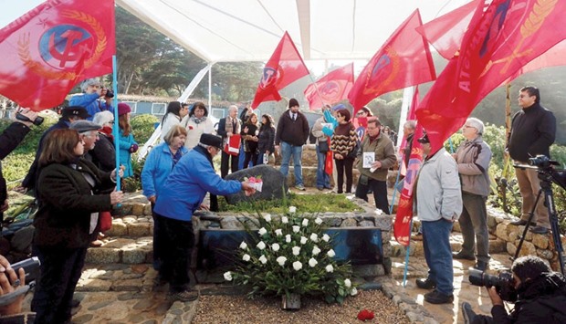 Members of the communist party pay tribute next to the tomb of Nobel laureate Pablo Neruda during the reburial of his remains inside of his house-museum in Isla Negra city, Chile, yesterday.