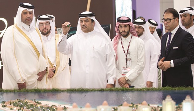 HE the Minister of Economy and Commerce Sheikh Ahmed bin Jassim bin Mohamed al-Thani (left) visits the UDC stand at Cityscape Qatar 2016. He is being briefed by UDC president and CEO Ibrahim Jassim al-Othman (third from left) on their projects and properties at The Pearl-Qatar as Hussain Akbar al-Baker and other officials look on.