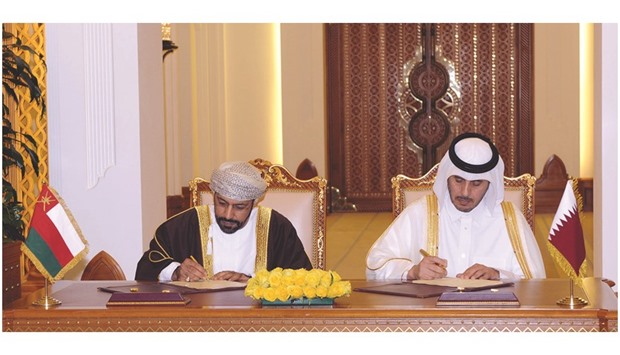 HE the Prime Minister and Minister of Interior Sheikh Abdullah bin Nasser bin Khalifa al-Thani and Omani Interior Minister  Hamoud bin Faisal al-Busaidi signing a co-operation agreement in Doha yesterday.
