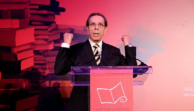 Palestinian writer Rabai al-Madhoun gestures after receiving the international prize of Arabic fiction in Abu Dhabi.