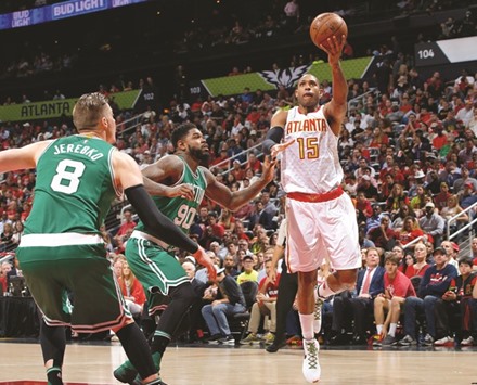Al Horford #15 of the Atlanta Hawks attacks the basket against Amir Johnson #90 and Jonas Jerebko #8 of the Boston Celtics in Game Five of the Eastern Conference quarters.