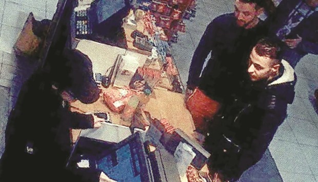 This file video image taken from a CCTV camera at a petrol station in Ressons, north of Paris, on November 11, 2015 shows Abdeslam (right) and Mohamed Abrini buying goods. Abdeslam was handed over to French authorities yesterday, federal prosecutors in Belgium said.