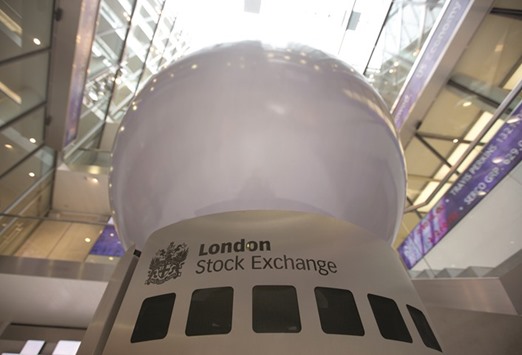 A logo is displayed on an interactive sculpture in the main atrium of the London Stock Exchange headquarters. The FTSE 100 closed down 0.2% to 6,309.42 points yesterday.
