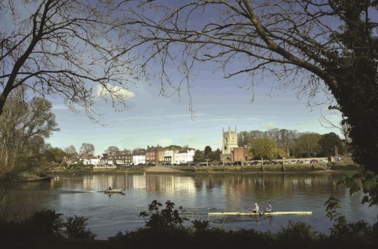 Rowers pass Old Isleworth as they train on the River Thames in west London.