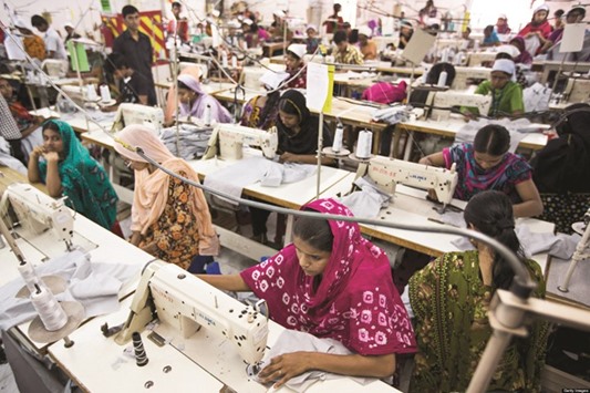 Workers sew garments at a factory in Dhaka. The textile industry is the most female-intensive sector in Asia with women making up 71% of its workforce in Sri Lanka, 35% in India and 34% in Bangladesh.