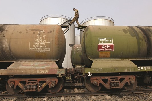 A worker walks atop a tanker wagon to check the freight level at an oil terminal on the outskirts of Kolkata. Indiau2019s imports of oil from Iran last month totalled 506,100 bpd, the highest in five years, the data showed yesterday.