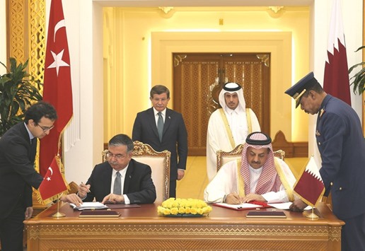 HE the Prime Minister and Minister of Interior Sheikh Abdullah bin Nasser bin Khalifa al-Thani and Turkish Prime Minister Dr Ahmet Davutoglu witness the signing of an agreement yesterday in Doha.