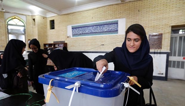 An Iranian woman casts her ballot in the second round of parliamentary elections at a polling station in Robat Karim, some 40 kms southwest of Tehran, on Friday.