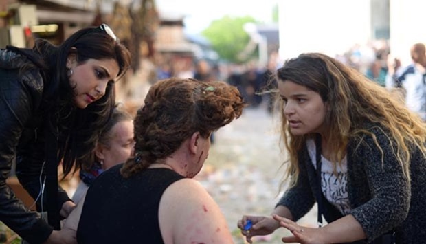A woman gives first aid to an injured woman following a bombing in Bursa this week.