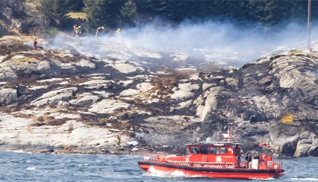 Rescue forces work at the shore west of Bergen, Norway after a helicopter crash