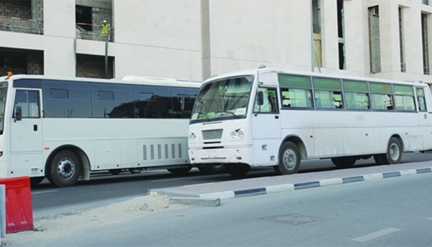 An air-conditioned and a non-AC bus parked next to each other on a Doha road.  PICTURE: Najeer Ferok