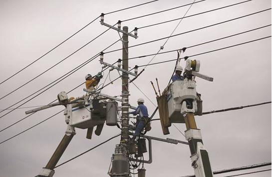 Men work around an electric pole in Urayasu, Tokyo. Four weeks into Japanu2019s power market shakeup aimed at boosting choice and energy security, the utility at the centre of the 2011 nuclear crisis has borne the brunt of consumer defections, with nearly 470,000 users switching electricity providers.