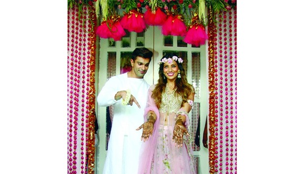 Bollywood actors Karan Singh Grover (left) and Bipasha Basu pose for a photograph during their mehendi marriage ceremony in Mumbai yesterday.
