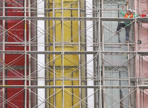 A construction worker climbs a scaffolding outside a shopping centre under renovation in Taipei. Taiwanu2019s economy is clearly struggling to shake off last yearu2019s recession as prolonged weakness in global demand weighs on Asiau2019s exporters, even those such as Taiwan which sell popular, higher-end products such as smartphones.