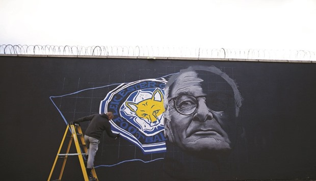 Artist Richard Wilson spray paints a mural of Leicester City manager Claudio Ranieri in Leicester yesterday.