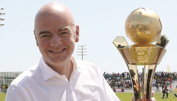 FIFA president Gianni Infantino gestures next to Workers Cup trophy during the semi-final between Taleb Group and Larsen & Toubro last week.