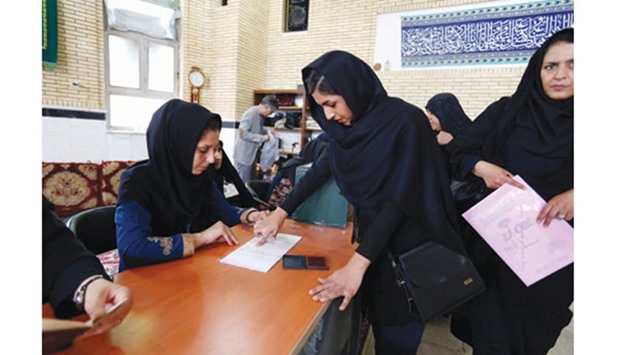 An Iranian woman casts her ballot to vote in the second round of parliamentary elections at a polling station in the town of Robat Karim, some 40 kms southwest of the capital Tehran yesterday.