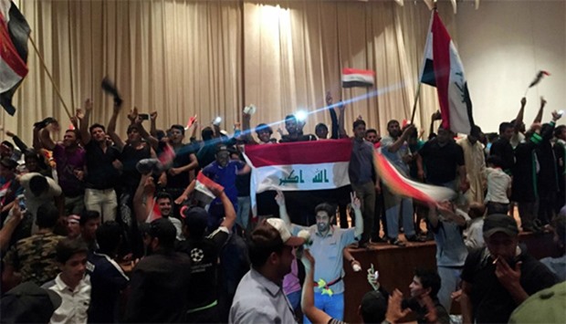 Followers of Iraq's Shia cleric Moqtada al-Sadr are seen in the parliament building as they storm Baghdad's Green Zone