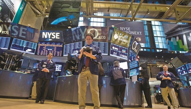 Traders work on the floor of the New York Stock Exchange. Coming off a barrage of flimsy company earnings reports, investors will turn to April jobs data for signs of budding resilience or further weakening in the second quarter.