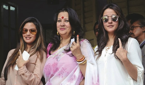 Trinamool Congress MP and veteran actress Moon Moon Sen and her daughters Riya and Raima show their forefingers marked with ink after casting their votes at a polling booth in Kolkata yesterday.