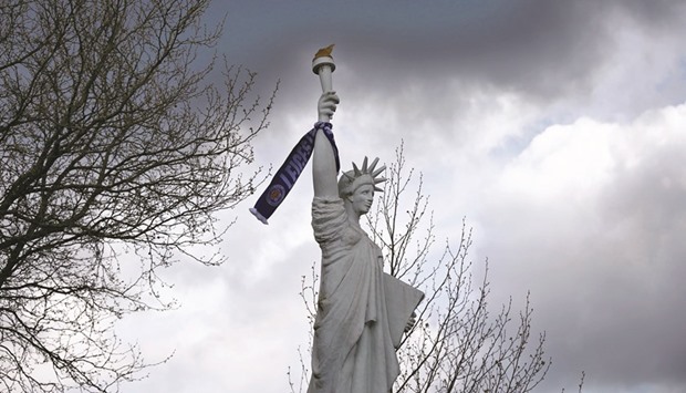 A Leicester City scarf hangs from the Liberty Statue in Leicester. The city's local landmarks have been lit up in blue in anticipation of the teamu2019s first major silverware since the 2000 League Cup. (Reuters)