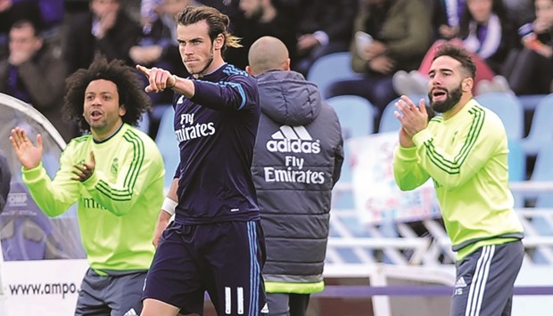 Real Madrid forward Gareth Bale celebrates his goal against Real Sociedad with teammates Marcelo (left) and Dani Carvajal. (AFP)