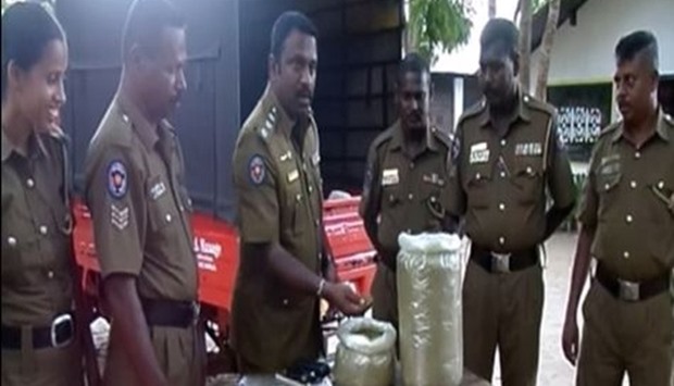 Sri Lanka police inspect seized packages of drugs
