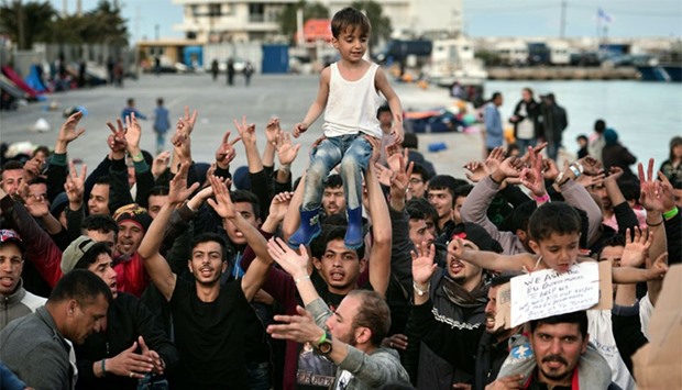 People shout 'No Turkey' at the port at the town of Chios where refugees and migrants who broke out from Vial detention center are camped out. AFP