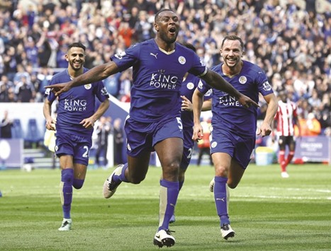 Leicester City captain Wes Morgan celebrates with team-mates Danny Drinkwater (right) and Riyad Mahrez after scoring against Southampton yesterday. (Reuters)