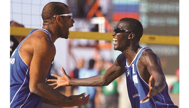 Qataru2019s Jefferson Pereira (left) and Cherif Younousse.