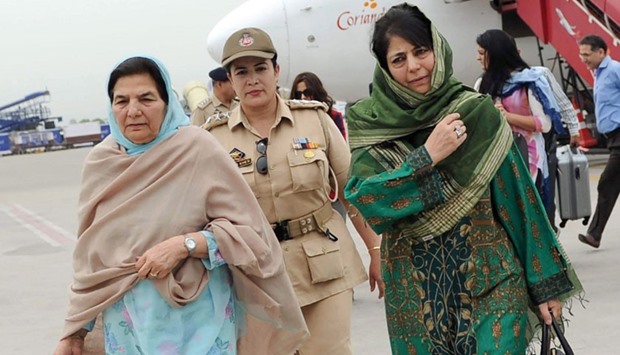 Peopleu2019s Democratic Party leader Mehbooba Mufti is accompanied by her mother Gulshan Ara Nazir and a security official as she walks from an aircraft upon her arrival in Jammu yesterday.