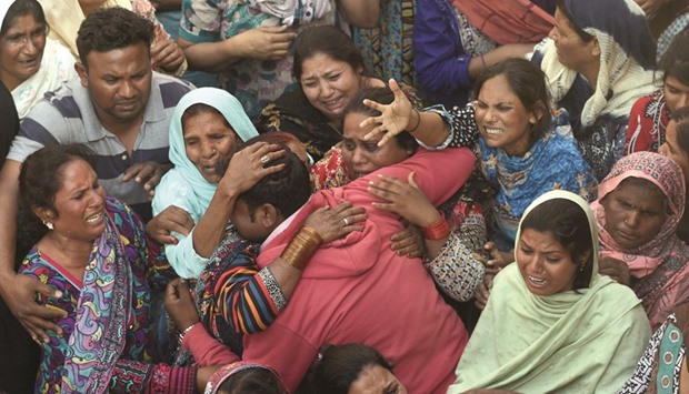 People mourning as they attend a funeral for a blast victim of the March 27 suicide bombing, in Lahore.