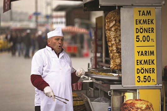 A street trader shouts to encourage customers to his food stall selling Turkish kebabs in Istanbul (file). Food prices were the single biggest contributor to the slowdown in inflation, falling 1.53% in March compared with a month before. On a yearly basis, they rose 4.58%.