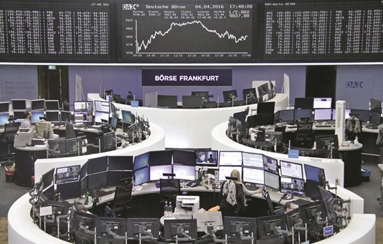 Traders work at the Frankfurt Stock Exchange. The DAX 30 closed up 0.3% to 9,822.08 points yesterday.