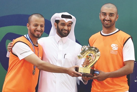 Supreme Committee for Delivery and Legacy Secretary-General Hassan al-Thawadi presents inaugural National Service Cup trophy to Orange Team members.