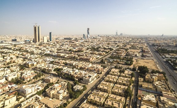 Residential housing and skyscrapers stand on the city skyline in Riyadh. The kingdom has been financing its deficit by selling local debt and drawing down on foreign reserves. The central banku2019s net foreign assets have tumbled by more than 500bn riyals ($133bn) since the start of 2015 to 2.19tn riyals in February. The government will accelerate subsidy cuts and impose more levies as part of its plan to boost non-oil revenue by $100bn annually by 2020.