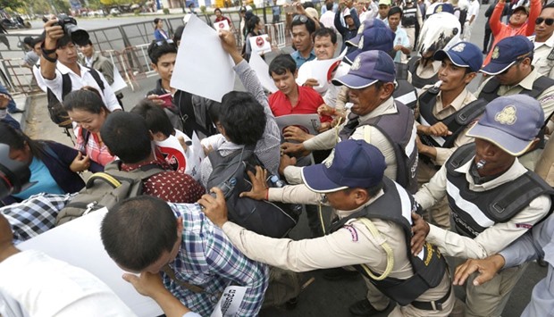 Cambodian security officers push back protesters to prevent them from reaching the National Assembly during a protest against the trade union law in Phnom Penh yesterday.