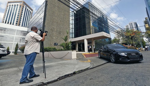 A cameraman stands outside the Arango Orillac Building where the Mossack Fonseca law firm is situated in Panama City.