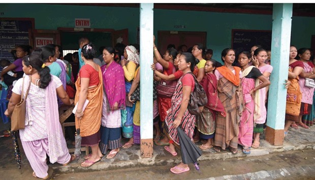 Women queue to cast their ballots in the state assembly elections at a polling station in Diphu in the Karbi Anglong district some 215km from Guwahati in Assam yesterday.
