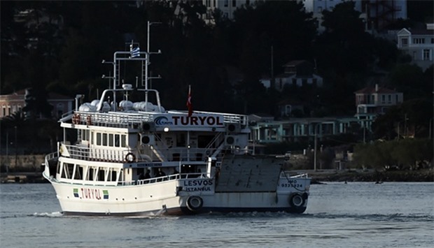 A small Turkish ferry carries migrants who are deported to Turkey from the port of Mytilene