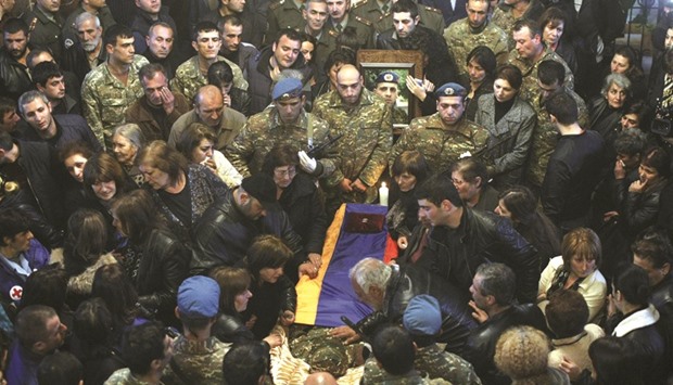 Armenians surround a coffin of a serviceman, killed in clashes in the breakaway Nagorno-Karabakh region, during a memorial service at a church in Yerevan.