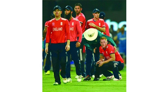 Ben Stokes (right) is comforted by team members after he bowled the final over and was hit for four sixes as England lost to West Indies in the final of the World Twenty20 at The Eden Gardens Cricket Stadium in Kolkata. (AFP)
