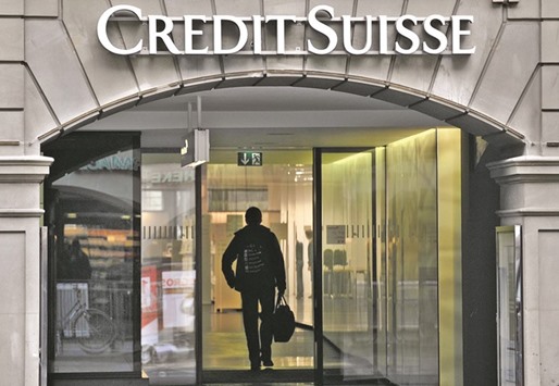 A man enters a Credit Suisse branch in Bern. The bank is seeking to cement its position as one of the biggest investment banks and wealth managers in Asia at a time when competitors from Barclays to Standard Chartered are cutting jobs, its group CEO Tidjane Thiam said yesterday.