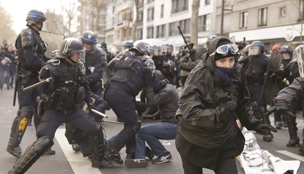 Anti-riot police officers clash with high school students on Boulevard Diderot in eastern Paris during a protest yesterday against the planned labour reform.