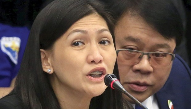 Maia Santos Deguito, branch manager of the Rizal Commercial Banking Corp (RCBC) answers questions during a money laundering hearing at the Senate in Manila yesterday. At right is her legal counsel Fernando Topacio.