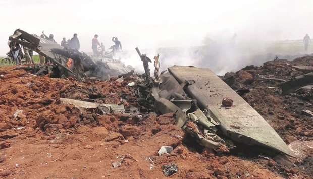 The wreckage of a Syrian warplane shot down by rebels near Aleppo yesterday.