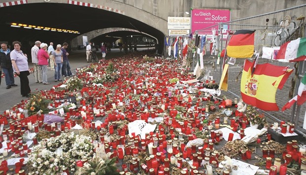 This August 6, 2010 file photo shows candles and flowers laid down at the site where the victims of the Love Parade stampede died in Duisburg, western Germany.