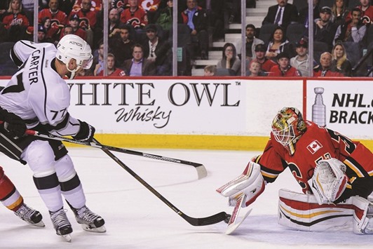 Jeff Carter of the Los Angeles Kings scores the game-winning goal against Joni Ortio of the Calgary Flames during an NHL game at Scotiabank Saddledome in Calgary, Alberta, Canada. (Getty Images/AFP)