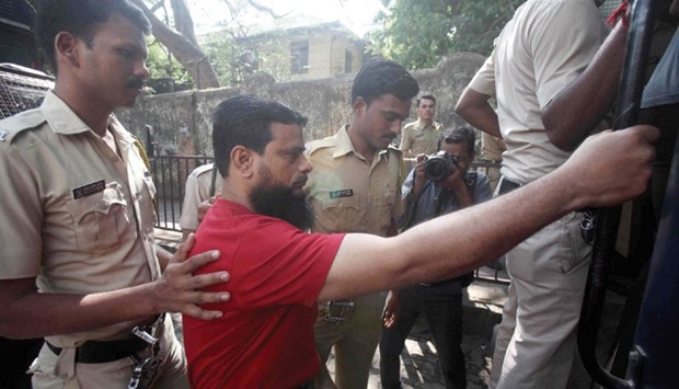 Police take one of the convicts to a court in Mumbai yesterday.