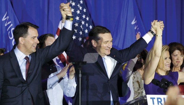 Republican presidential contender Ted Cruz celebrates with his wife Heidi and Wisconsin Governor Scott Walker at his Wisconsin primary night rally in Milwaukee.